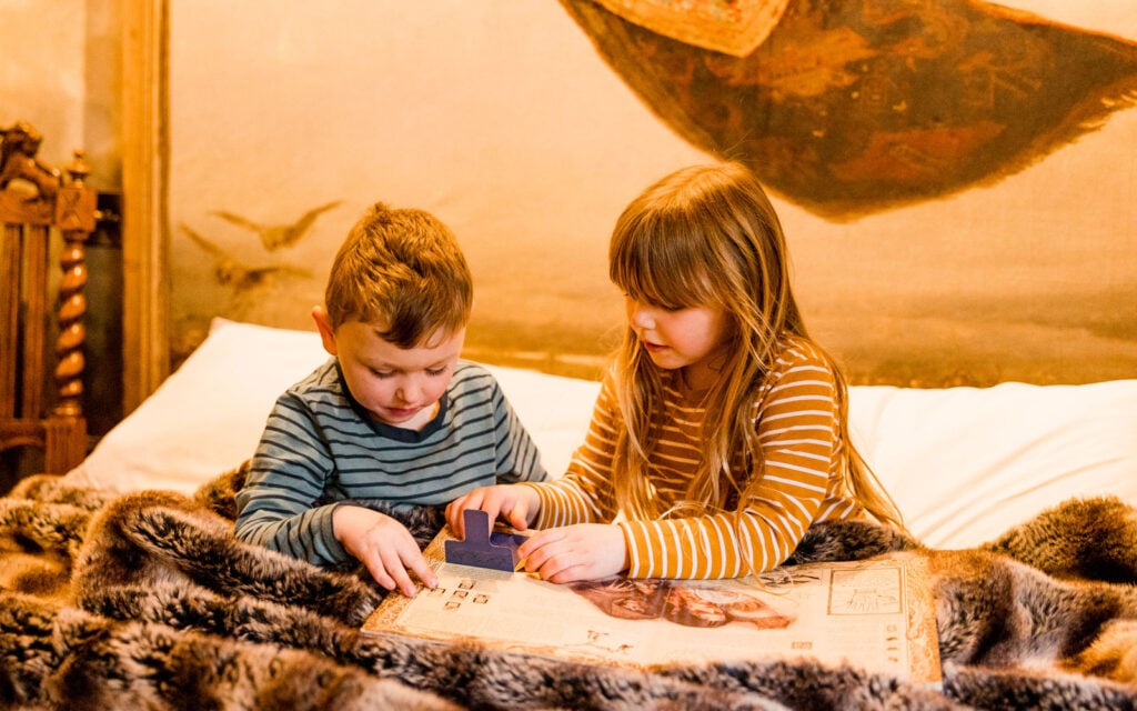 Children playing together inside a Dreamery Hideaway bothy bedroom
