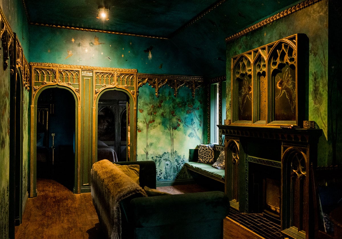 Living room with ornate fireplace inside King Auberons Bothy at The Dreamery Hideaway near York.
